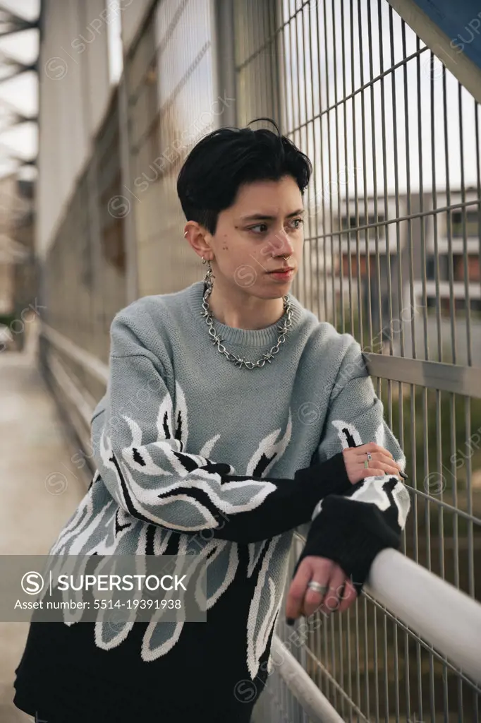 Lesbian girl with short hair leaning on a railing