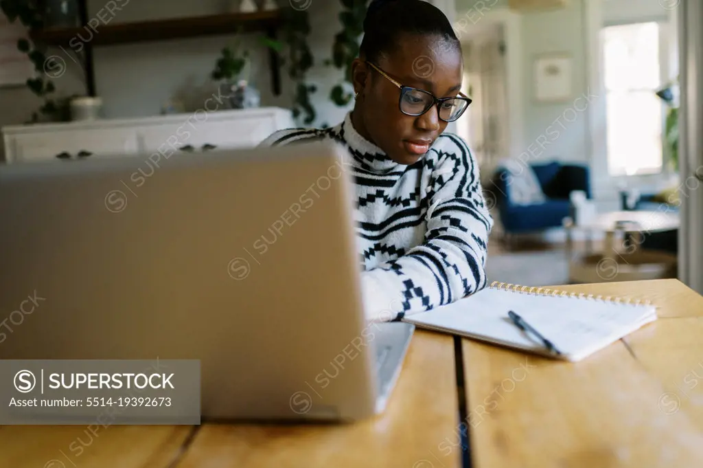 Teenage black girl studying for a test at home