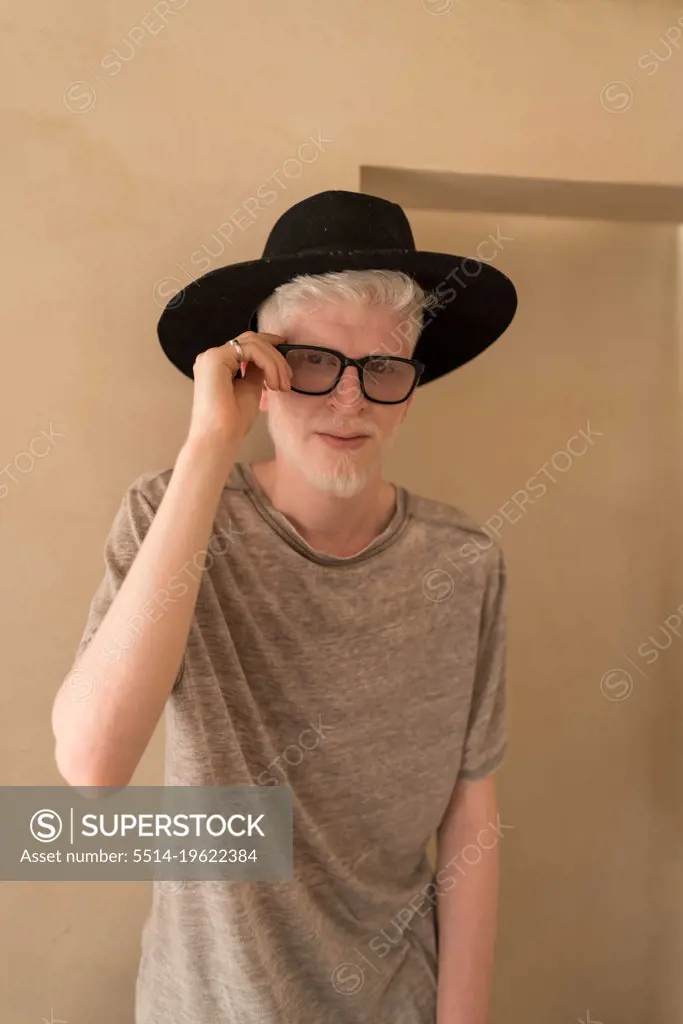 Albino man standing next to the wall portrait