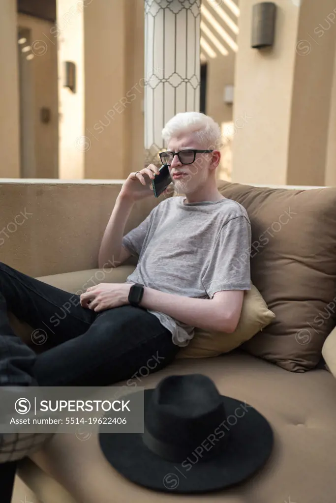 Albino man talking on the phone looking at camera