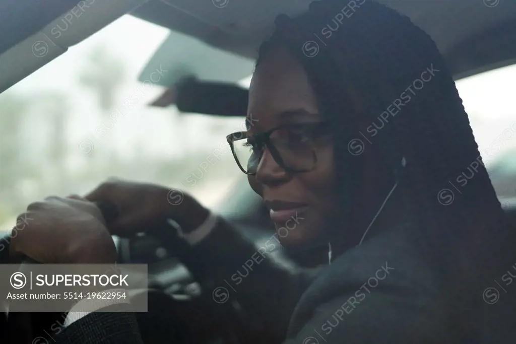 Black woman wearing smart casual sitting in the car
