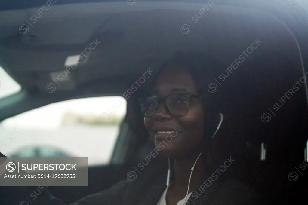 Black woman wearing smart casual sitting in the car