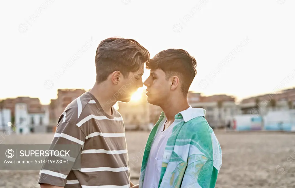 Intimate moment of a gay couple in the beach
