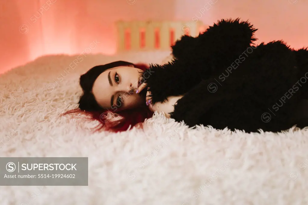 Portrait Of Beautiful Woman Lying On Bed
