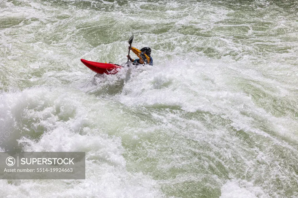 A kayaker surfing a wave in Lava Falls.
