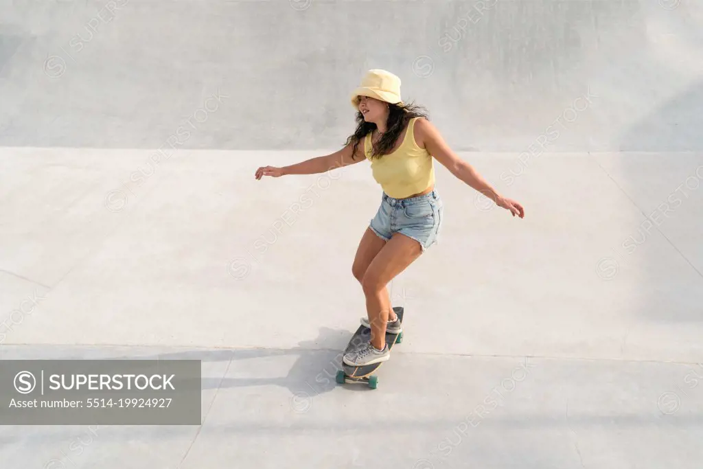 Asian woman skating in the skate park