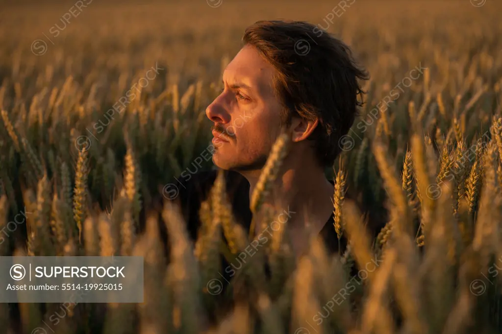 Concerned Male in His Thirties is Looking At the Light Away At Sunset