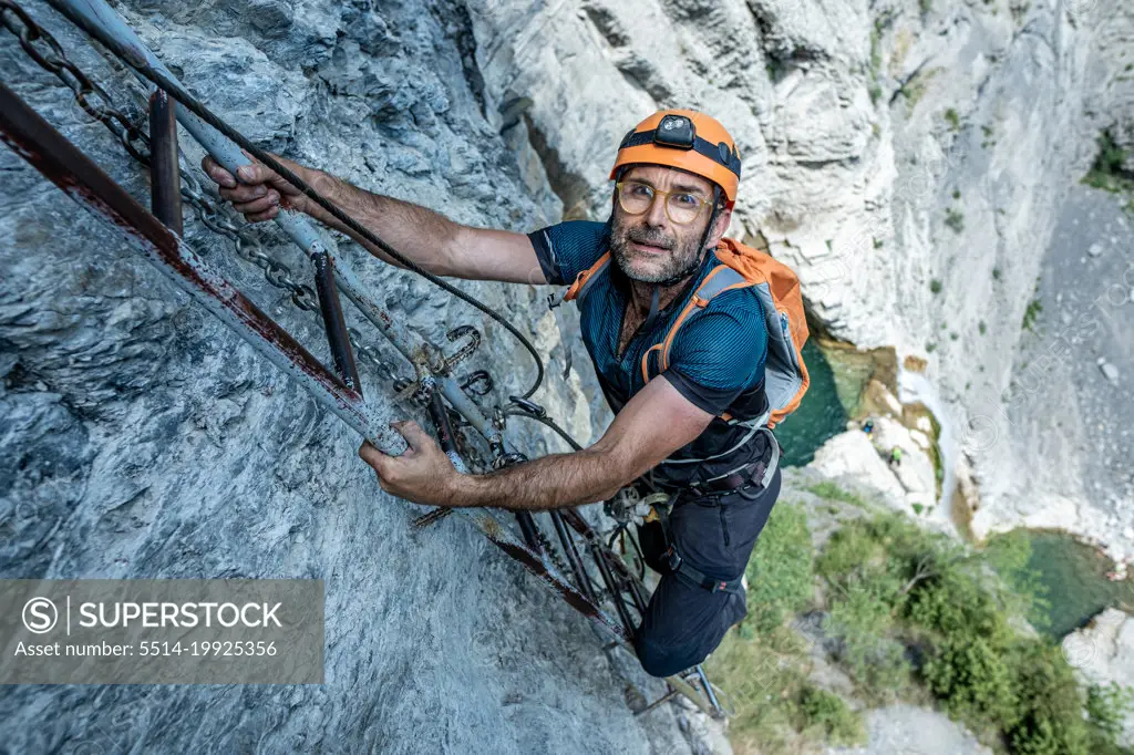 56-year-old male climber going up a via ferrata