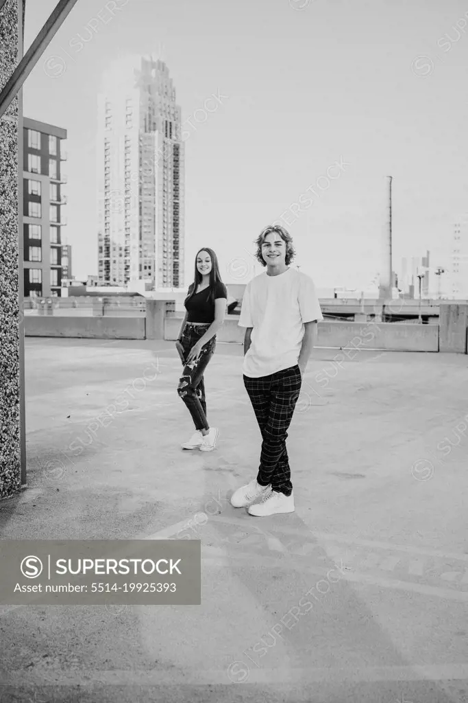teenage boy and girl standing on rooftop in downtown Minneapolis