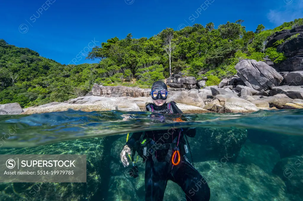 diver surfaces in the tropical waters of the Andaman Sea