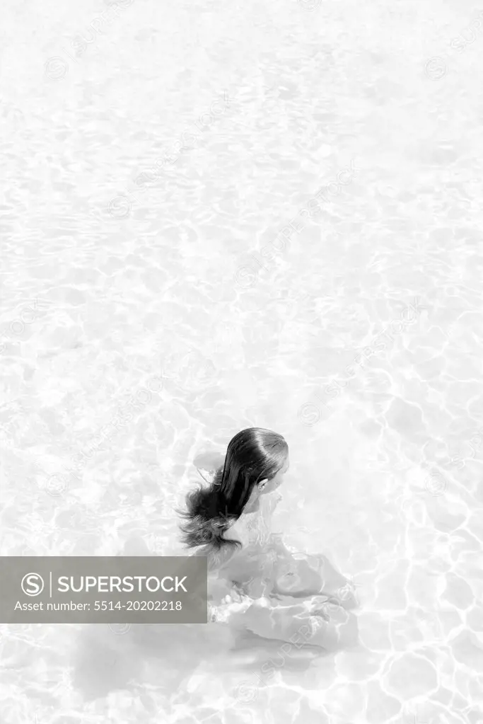abstract portrait in black and white of a girl in the ocean