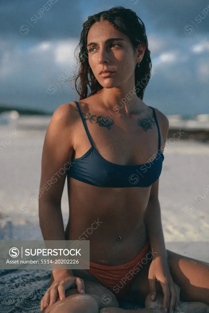 a beauty latin girl looking the sunset on the Mexican beach