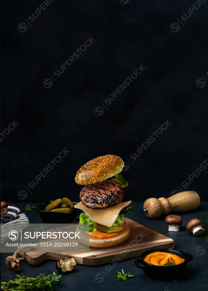 American burger on wood. Food styling. Food levitation
