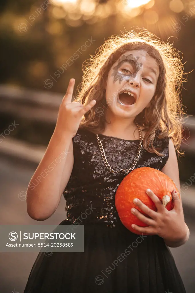 Teenage girl in hard rock costumes celebrate Halloween party