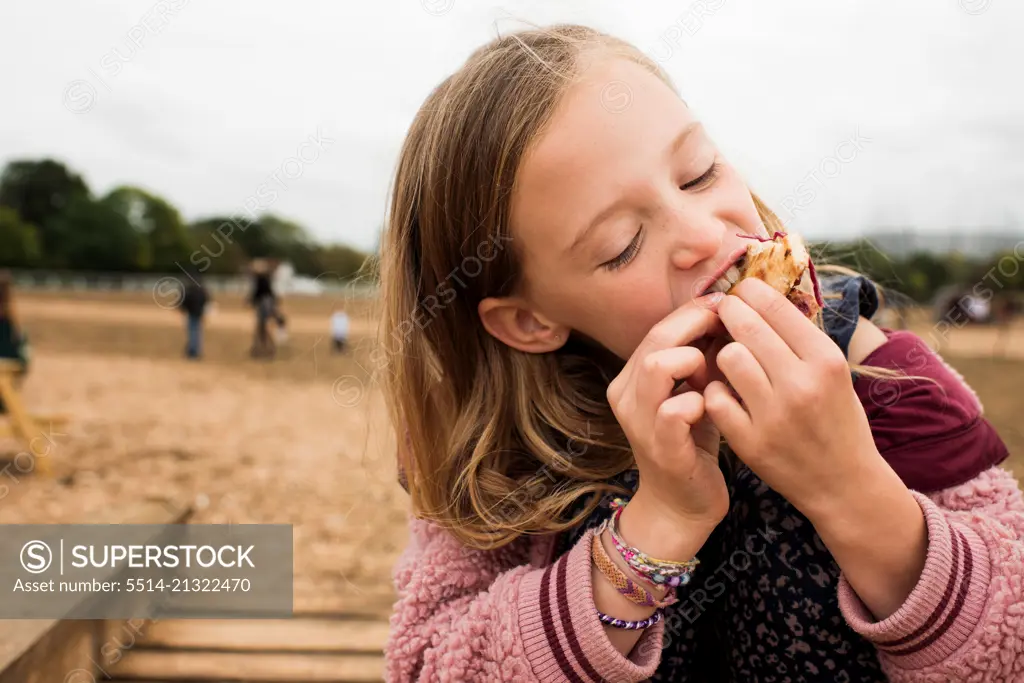 child enjoying street food whilst at a festival
