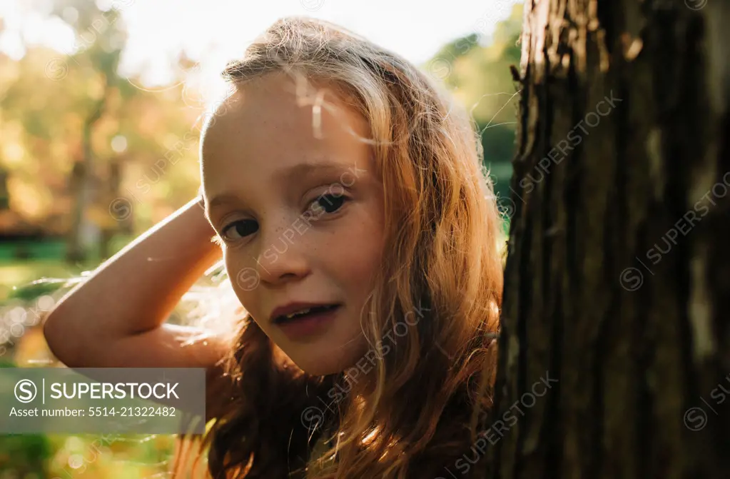 close up portrait of a child at golden hour in the forest