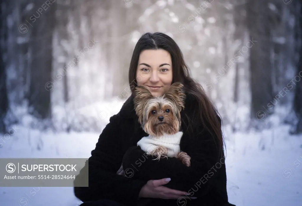 Winter portrait of a girl with her best friend - a dog