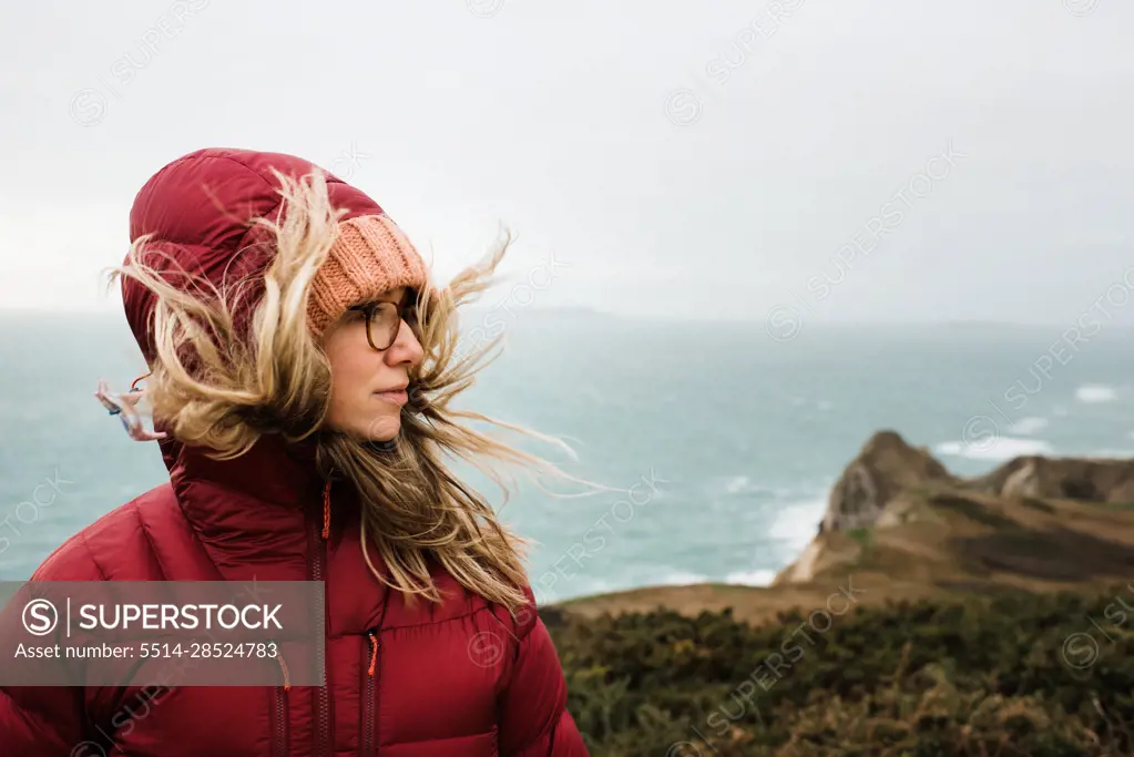 portrait of a woman hiking along the Jurassic coast in England