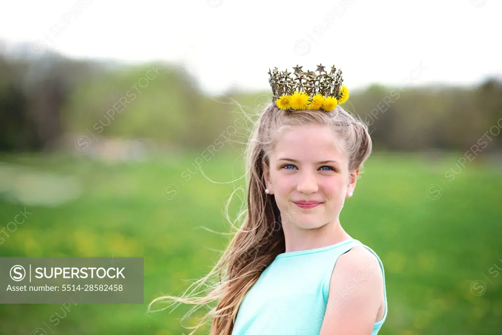 Pretty blond tween girl with dandelion crown.
