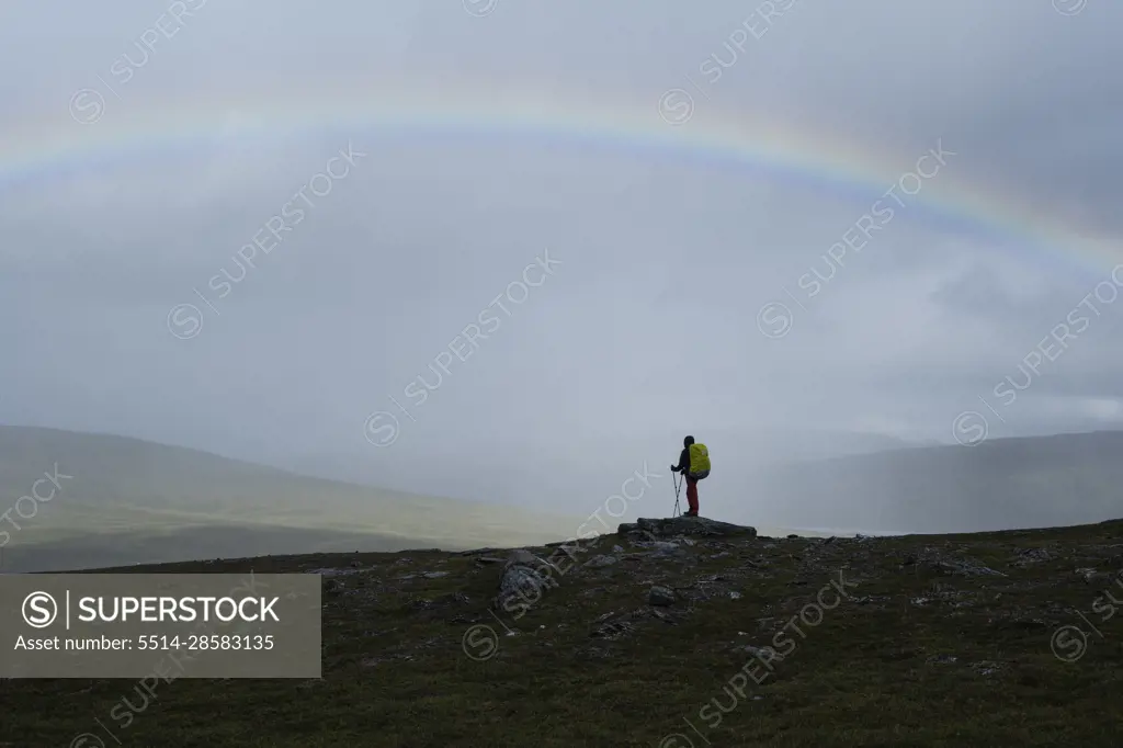 Hiker under rainbow, Padjelantaleden - Padjelanta trail, Sweden