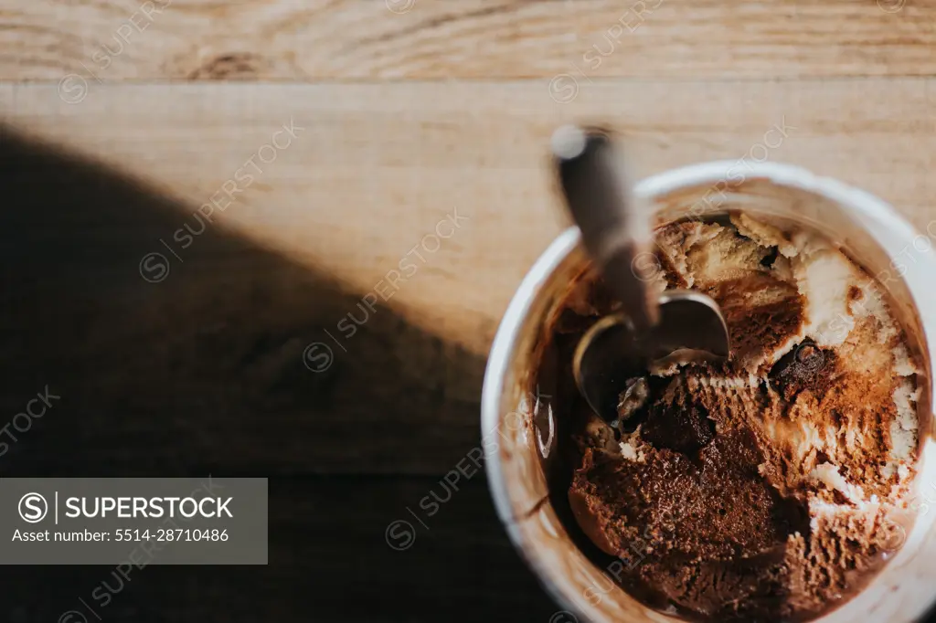 Ice cream with a spoon sitting in evening light