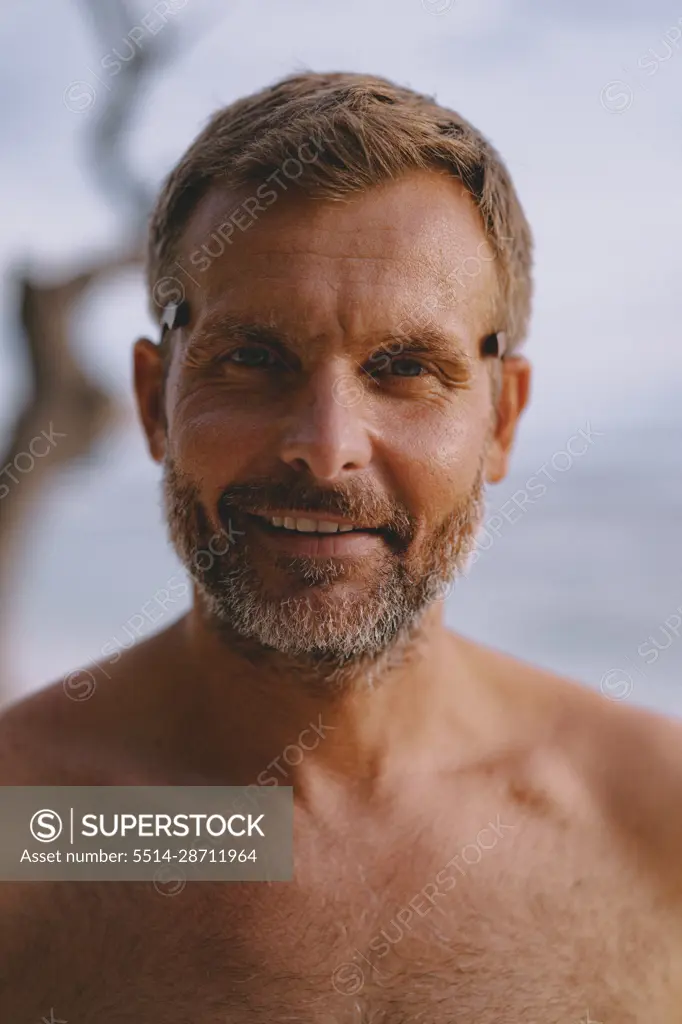 Portrait an attractive middle-aged man with a gray beard. - SuperStock