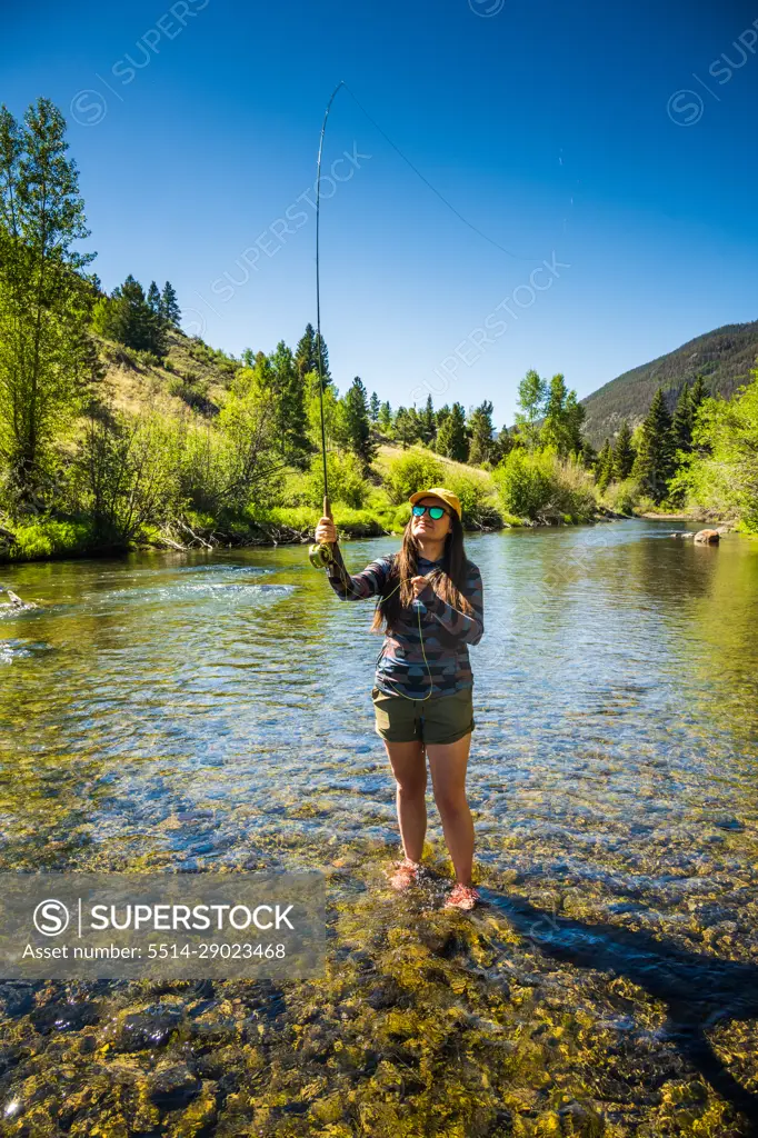 Woman Fly fishing on the Lake Fork River in Colorado - SuperStock
