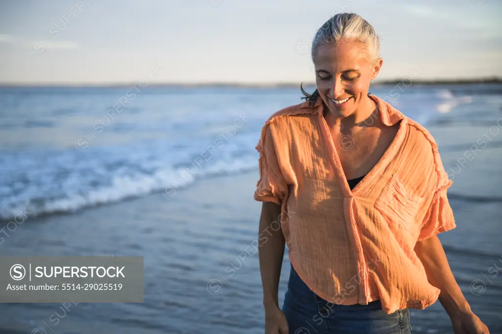 Gray Haired Woman enjoying the beach at sunset