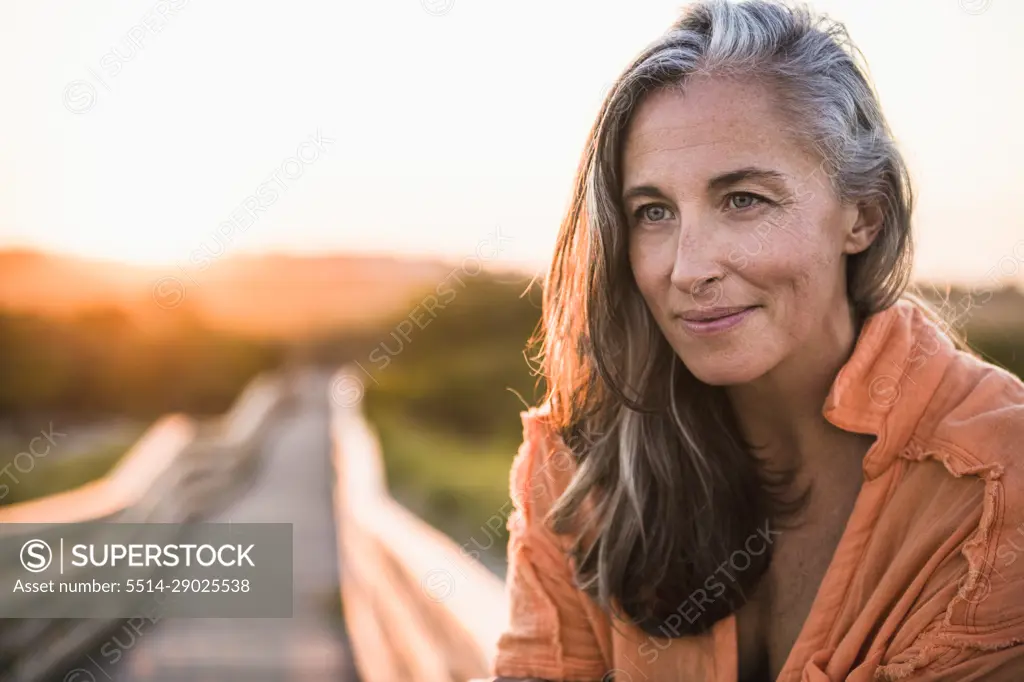 Portrait of Gray Haired Woman at the beach for sunset