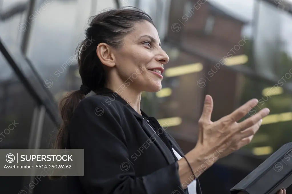 woman leader standing outside in front of a building