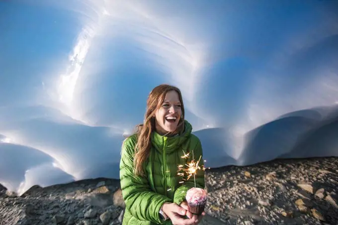 Adventurous woman celebrates her birthday in an ice cave.