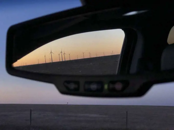 Looking in rearview mirror of wind turbines