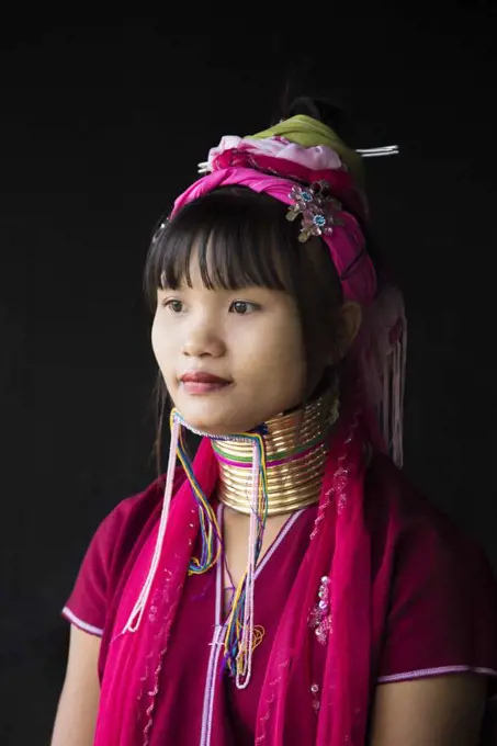 Young woman from the long neck tribe with black background, Inle Lake