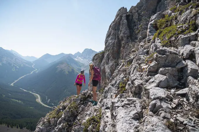 Two Women Scrambling The Rocky Mountains In Kananaskis Alberta