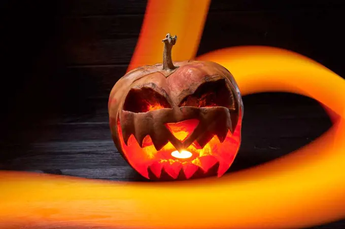 pumpkin for halloween on a black background with a long exposure