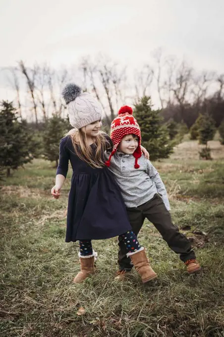 Boy and girl siblings at Christmas tree farm