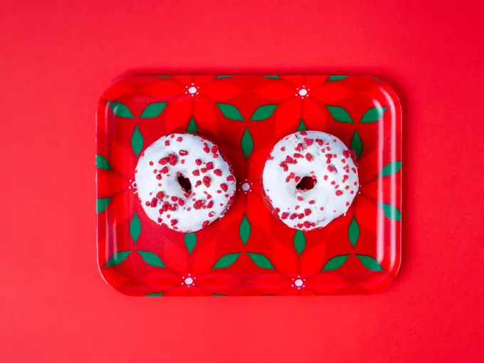 two doughnuts on a red tray
