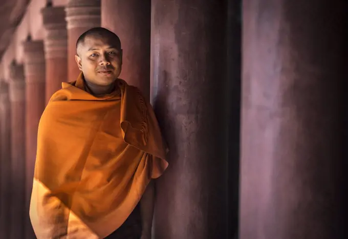 Portrait of a Buddhist monk dressed in orange robe, Mandalay, Myanmar