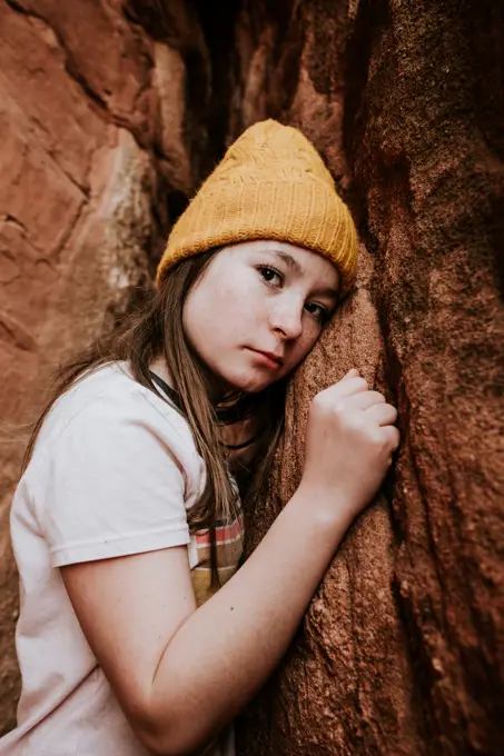 Vertical Portrait of preteen girl near red rocks