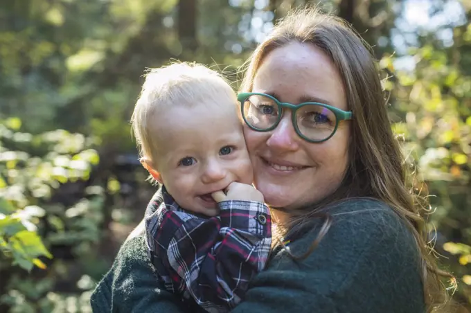 Outdoor portrait of a mother holding her one year old son.