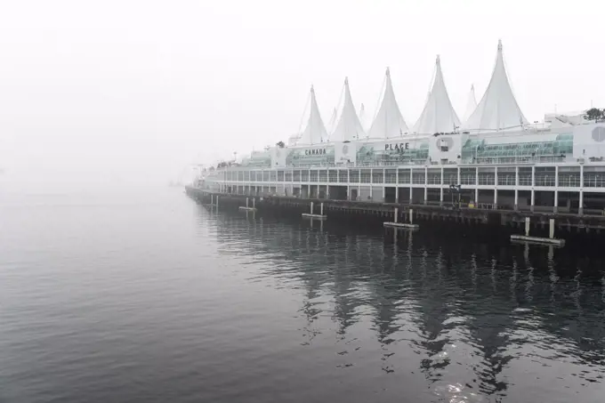 Canada Place at waters edge in Vancouver on foggy day