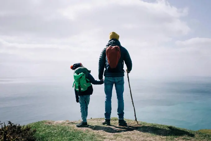 father and son stood at the top of the Jurassic coast in Dorset, UK