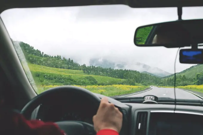 Man driving car on country road in Altai mountains.