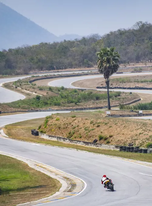 man practising laps on race track with his motorcycle