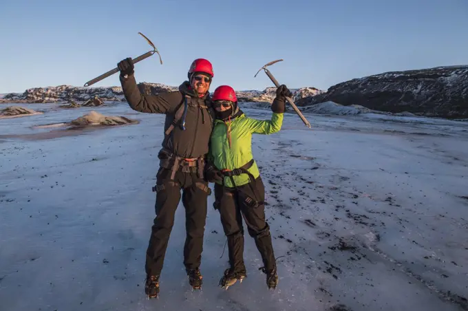 couple posing with ice pick on glacier in Iceland