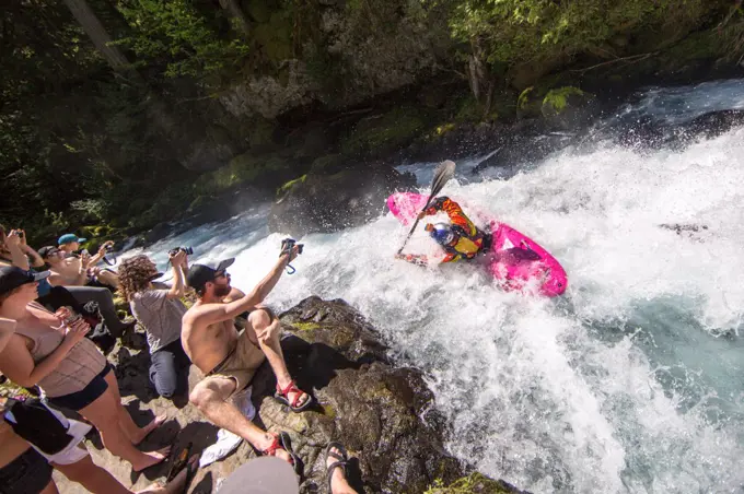 Whitewater kayaking waterfall with crowd