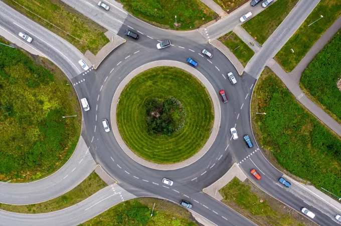 Roundabout on green landscape seen from above.