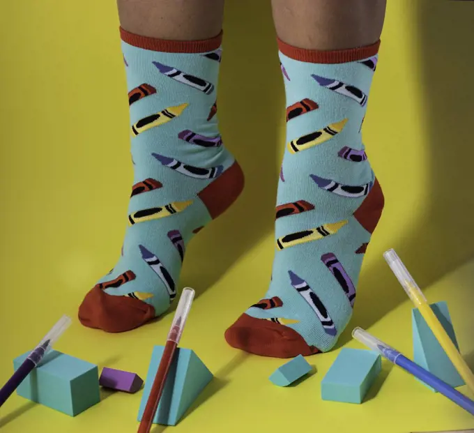 Woman wearing multicolored stylish socks with pencil pattern