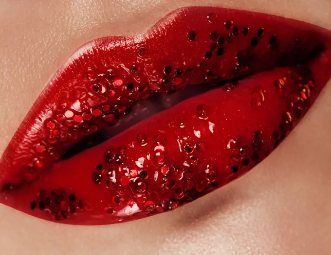 Closeup with female plump lips with christmas makeup.