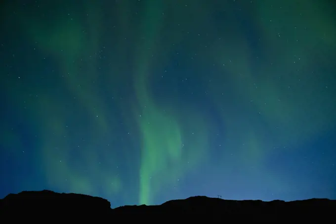 Aurora Borealis or Northern lights dancing in the sky above  Iceland